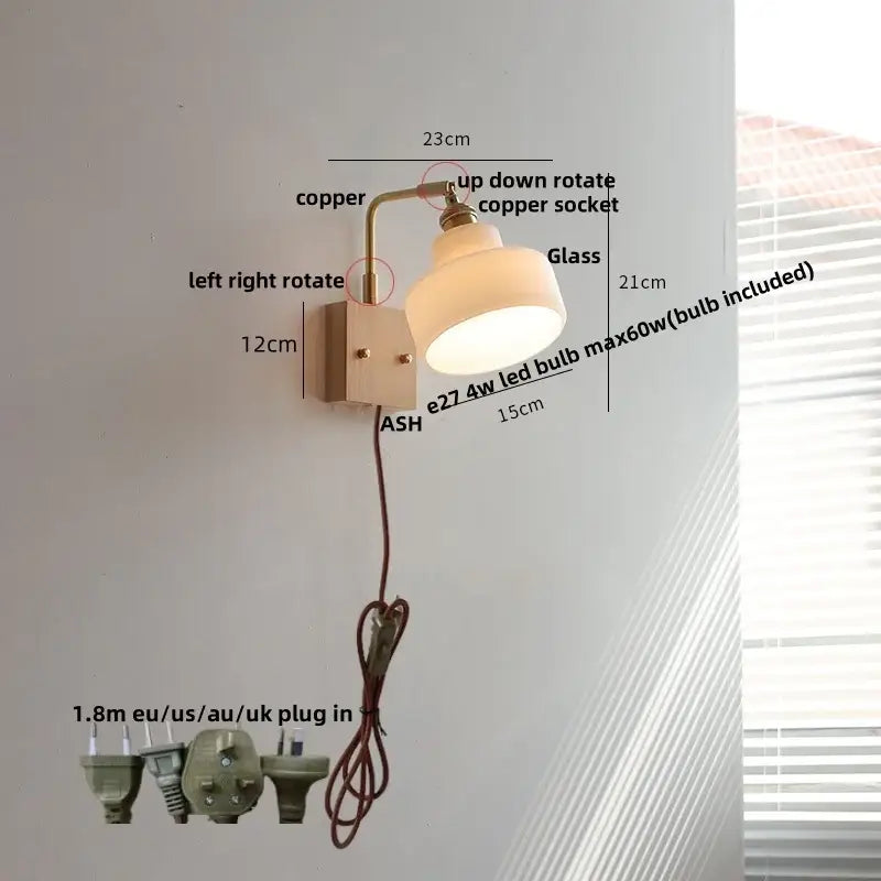 A warm-toned wall sconce with copper arm and off-white glass shade for vintage brass and glass pink led wall lighting