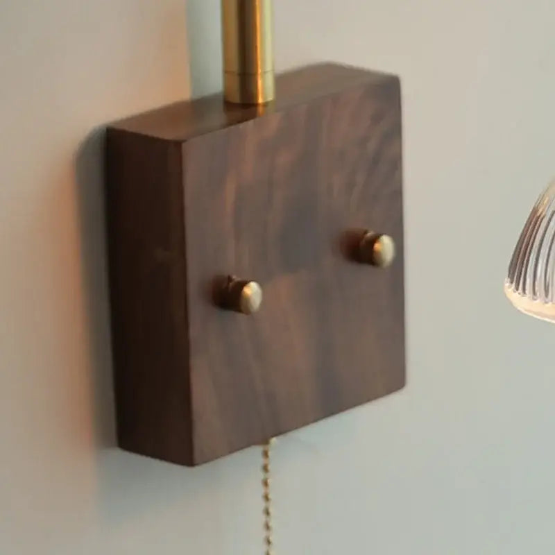 Dark wood wall sconce base with brass accents and two round knobs for vintage glass pink led wall lamp