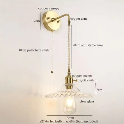 Antique brass-finished wall light with clear glass led shade and copper components for bedroom use