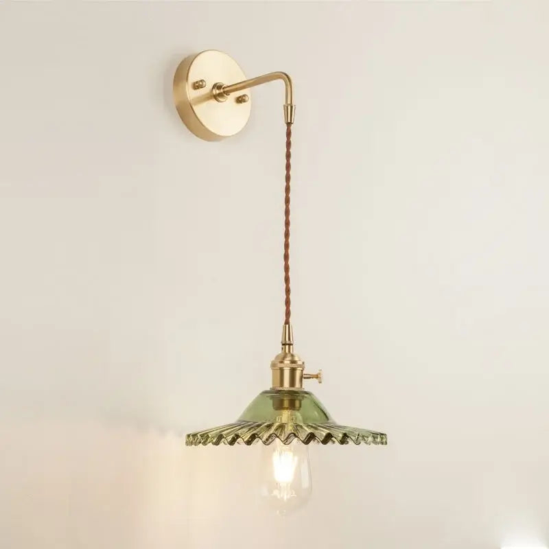 Vintage brass wall light with olive green glass led shade and scalloped edges for bedroom sconce lighting