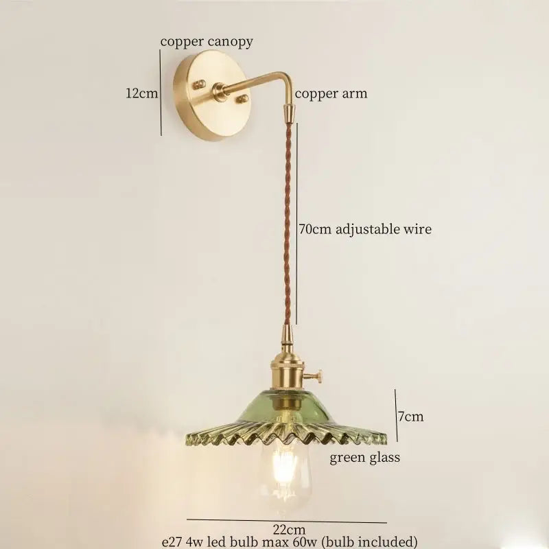 Vintage brass wall light featuring a green glass led shade and adjustable braided wire for bedroom use