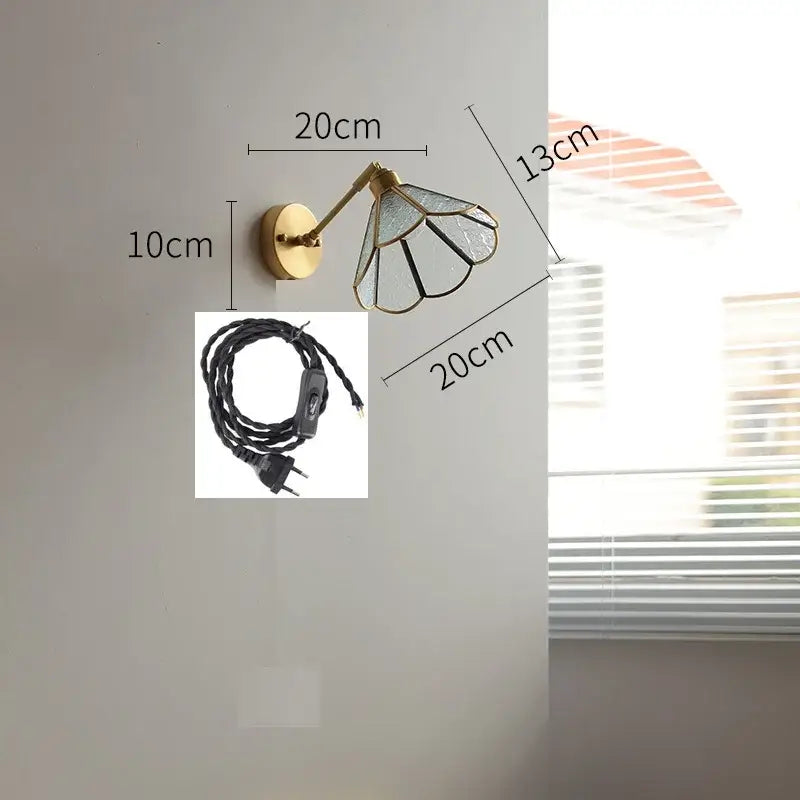 Brass-finished wall lights with black and clear stained glass shade featuring green glass led bedroom sconce design