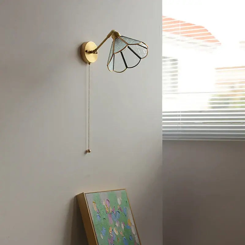 Vintage brass and green glass led wall lights with a gold-toned sconce and petal-like stained glass shade for bedroom use