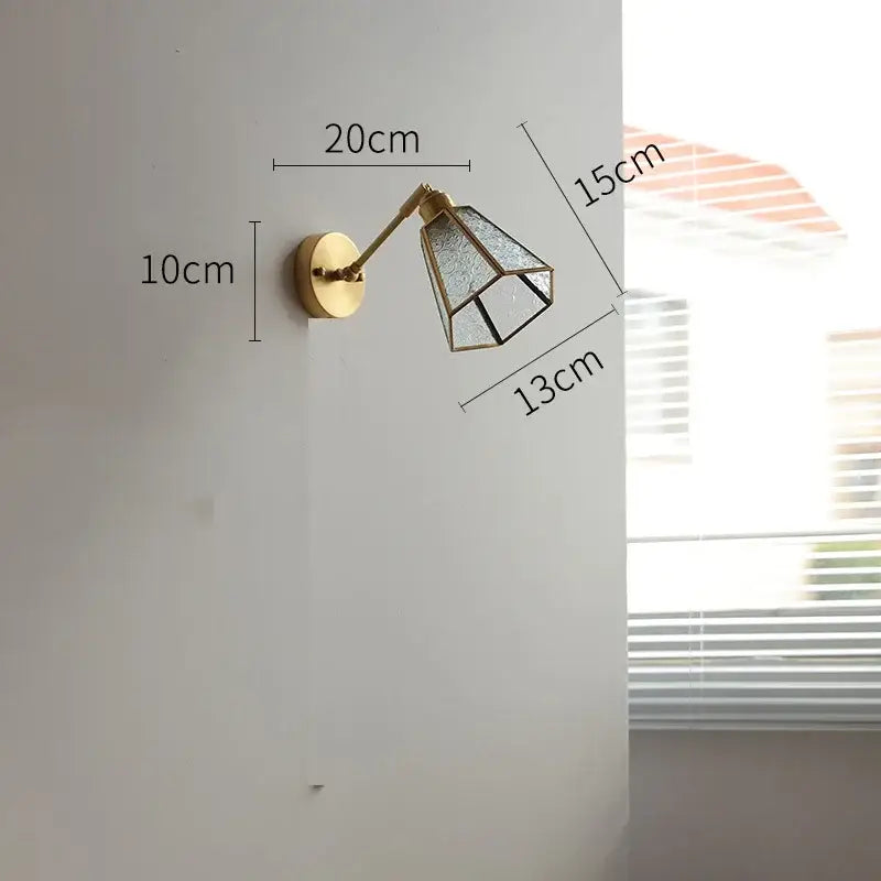 Vintage brass wall lights featuring a gold-toned sconce with a geometric green glass led shade for bedroom use