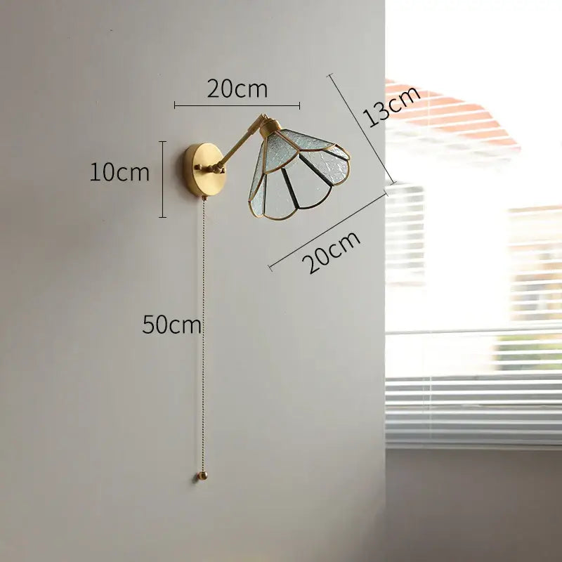Gold-toned vintage brass wall light with green glass led stained glass shade on circular brass base for bedroom sconce