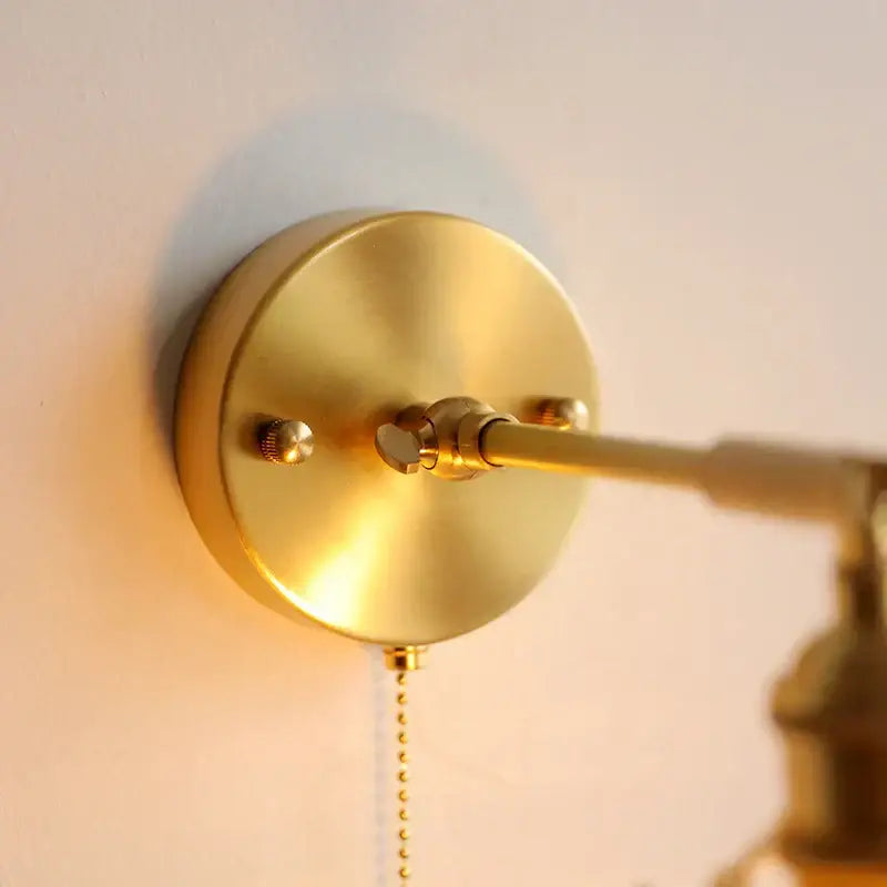 Gold-toned brass wall-mounted reading lamp with adjustable arm featured in vintage glass led wall lights bedroom sconce