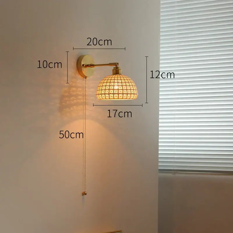 A vintage brass and green glass led wall light featuring a warm-toned woven rattan sconce with pull chain