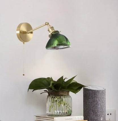 Vintage brass and green glass led wall sconce with ribbed glass and circular mount ideal for bedroom lighting