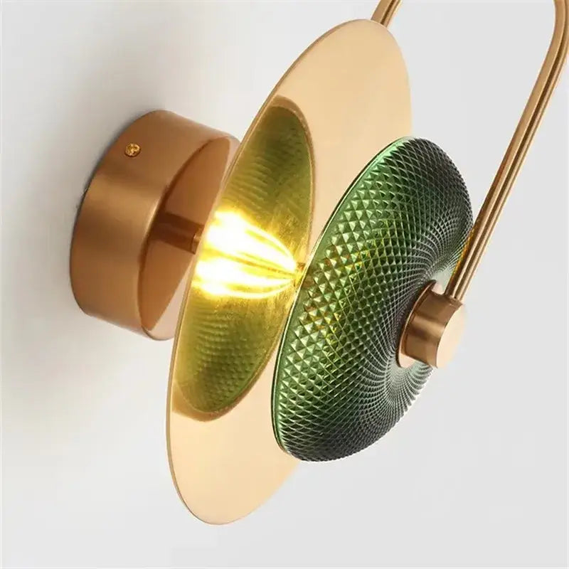 A vintage brass and green glass metal wall art light with concentric circular shades for living room wall lamp