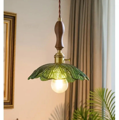 Vintage brass and green leaf led pendant lamp with dark wood handle and detailed glass shade for dining room lighting