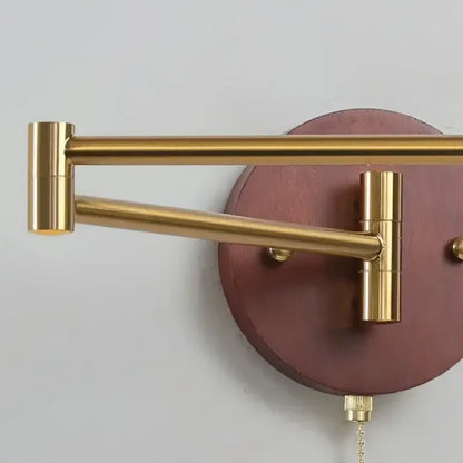 Gold-toned articulated wall lamp with maroon wooden backplate and brass hardware from decorbites creamy iron led collection