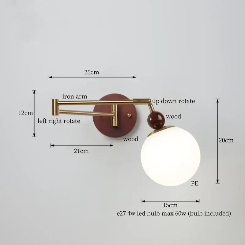 A modern adjustable wall lamp with brass iron arm, reddish-brown wooden base, and creamy iron led spherical shade by decorbites