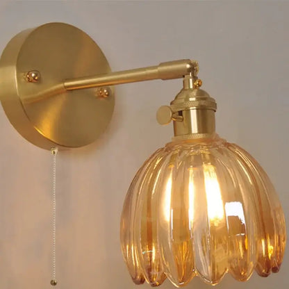 Gold-toned vintage brass wall light with ribbed amber glass vintage shade and pull chain for bedroom decorbites amber glass style