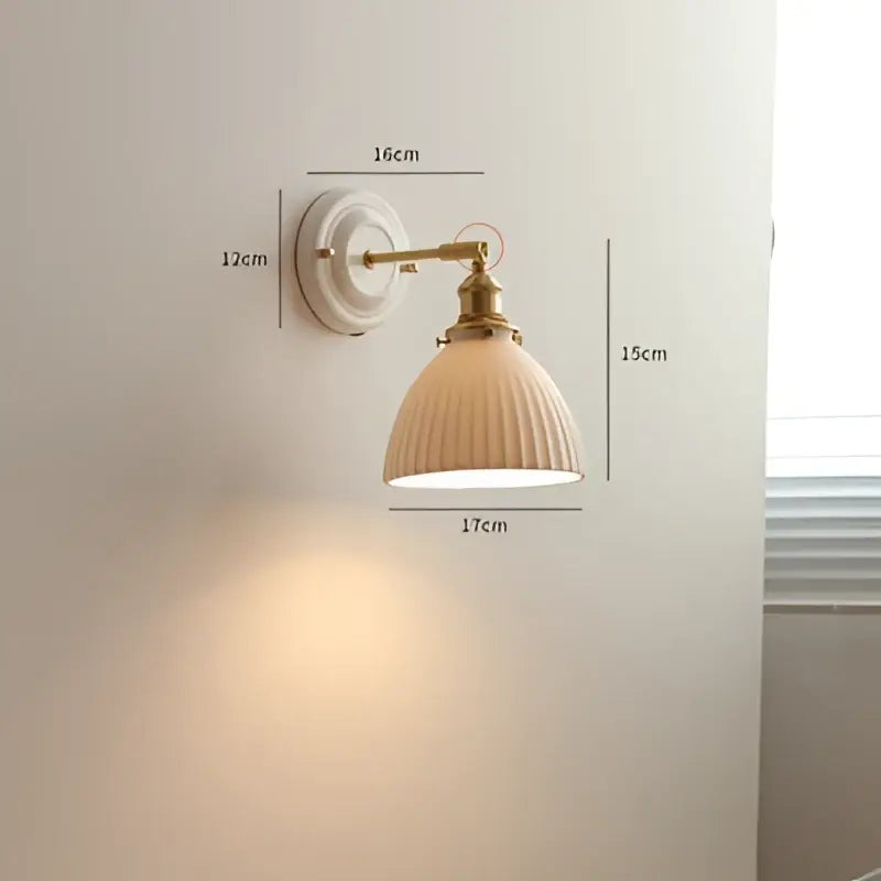 Cream-colored ribbed ceramic lampshade with brass-finished metal arm for vintage brass and ribbed glass led wall light