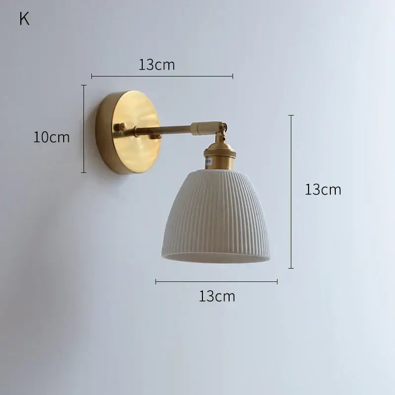 Vintage brass and ribbed ceramic led wall light with circular backplate for bedroom lighting use