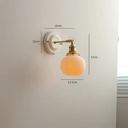 Vintage brass led wall light with frosted peach ribbed glass globe for elegant bedroom sconce lighting