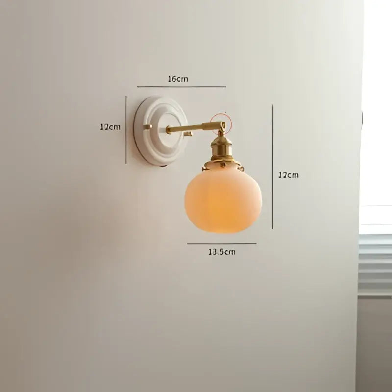 Vintage brass led wall light with frosted peach ribbed glass globe for elegant bedroom sconce lighting
