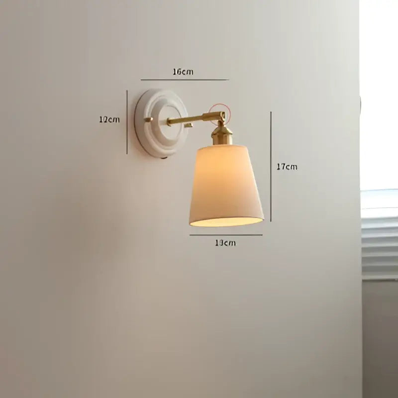 Vintage brass led wall light with ribbed glass and beige fabric shade diffusing warm light for bedroom sconce
