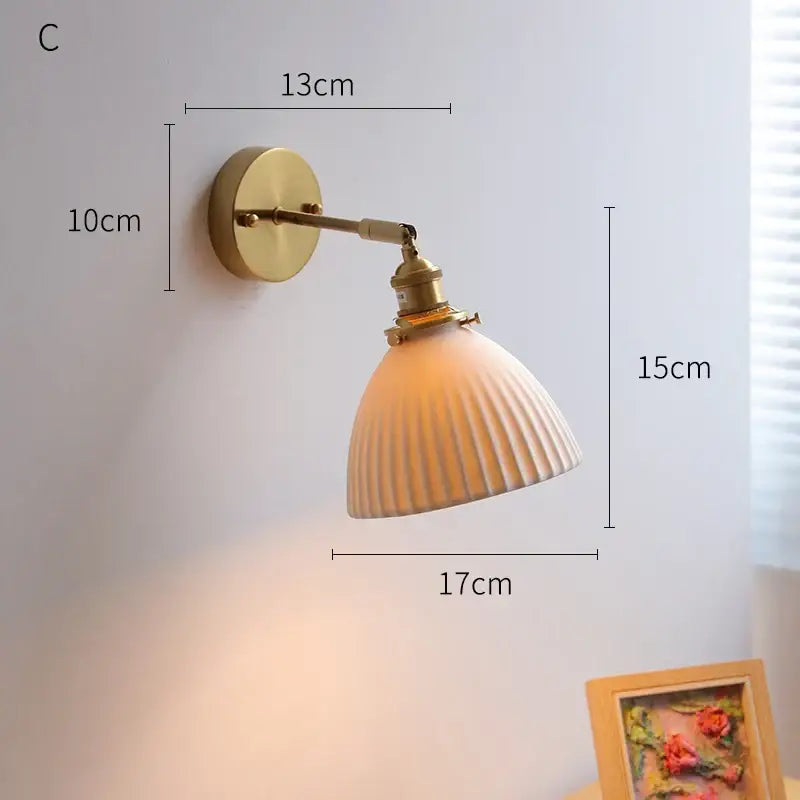 Vintage brass and ribbed glass led wall light with warm tones and adjustable arm for bedroom wall sconce lighting