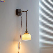 Vintage brass and ribbed glass led wall sconce with off-white shade and dark brown cord for bedroom decorbites led wall lighting