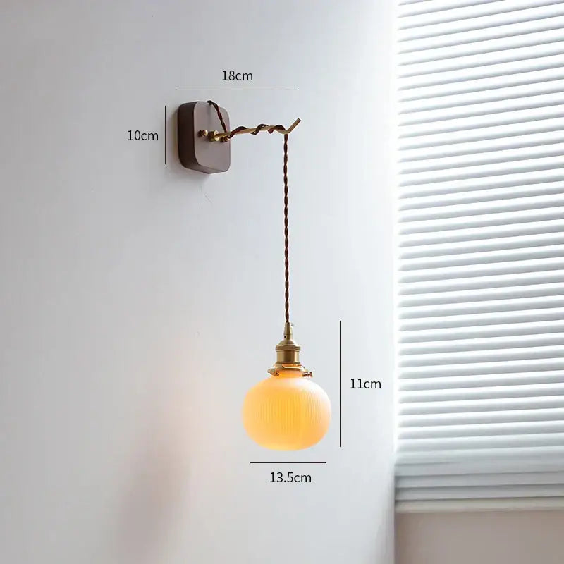 Vintage brass and ribbed glass led wall sconce with warm-toned globe and twisted cord for decorbites led wall lighting