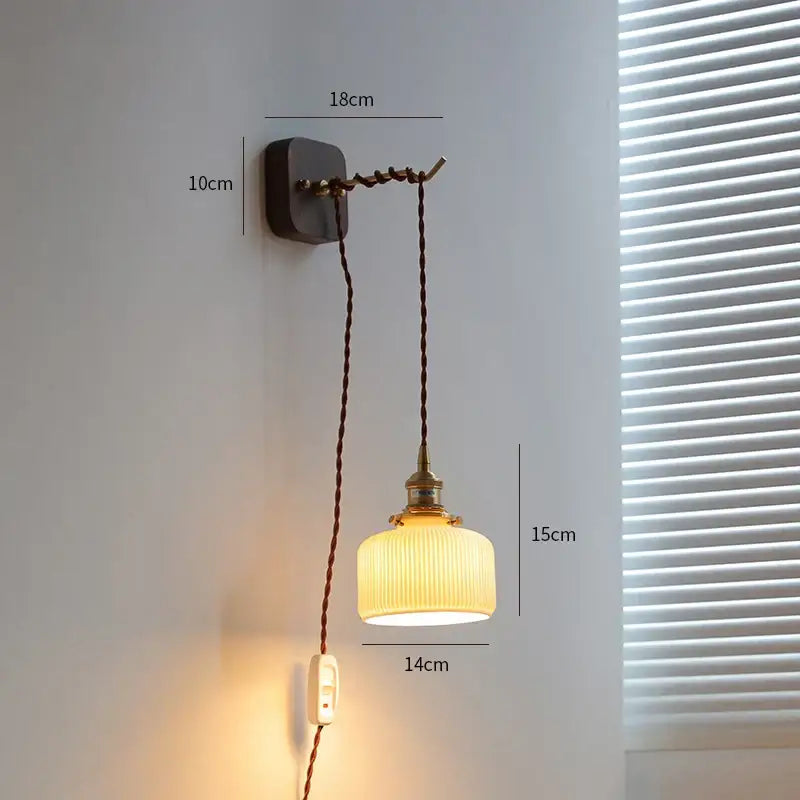 Vintage brass and ribbed glass led wall sconce with warm-toned glass and dark brown cord for bedroom decorbites led wall lighting