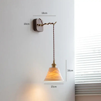 Vintage brass and ribbed glass led wall sconce with warm-toned textured glass and twisted brown cord decorbites led wall
