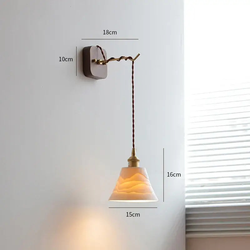 Vintage brass and ribbed glass led wall sconce with warm-toned textured glass and twisted brown cord decorbites led wall