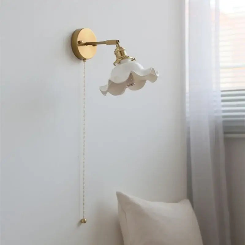 A delicate white ceramic led wall light with ruffled shade and vintage brass hardware for bathroom mirror decorbites ceramic led