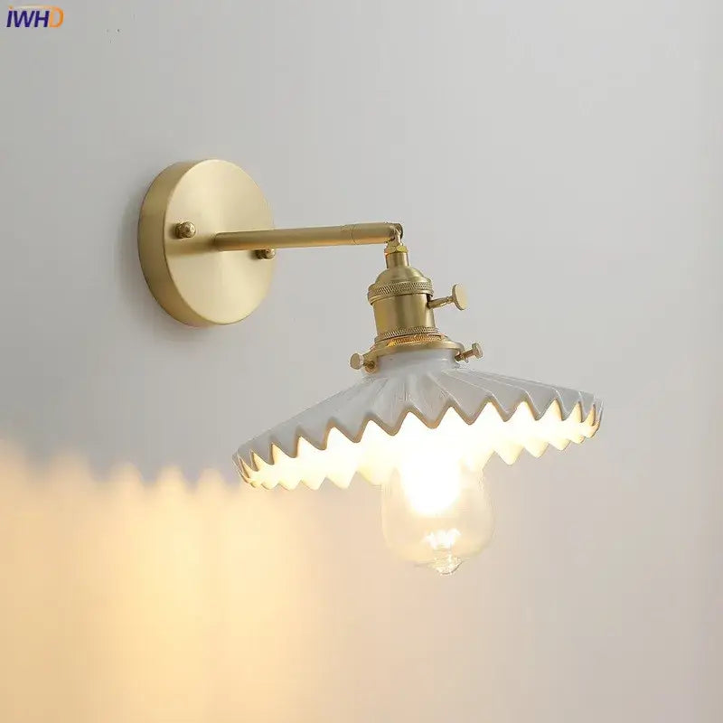 Vintage brass led wall lamp with scalloped white glass shade and exposed bulb for bedroom lighting