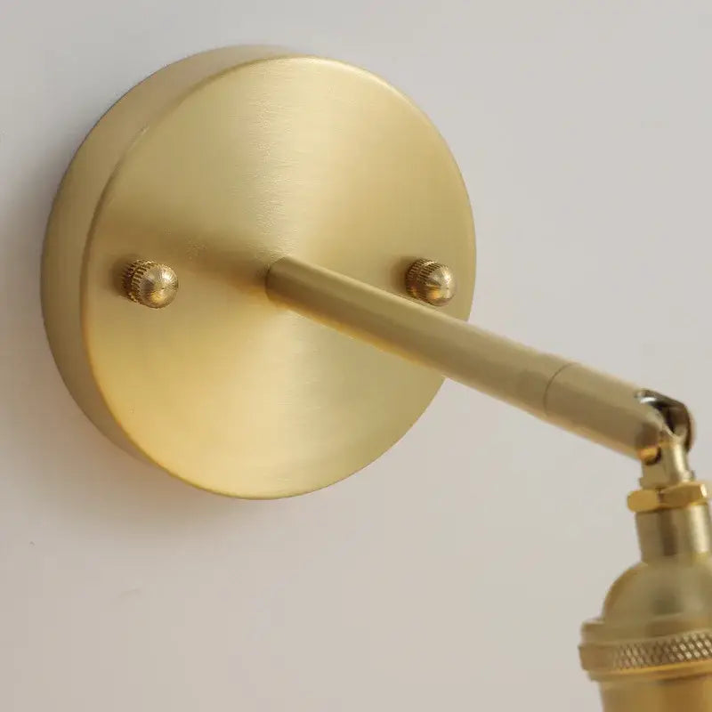 Vintage brass and scalloped glass led wall lamp with brass finish and adjustable minimalist design for bedroom use