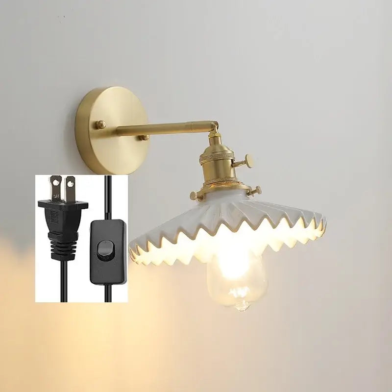 Vintage brass and scalloped glass led wall lamp with exposed bulb for bedroom featuring a brass-finished wall lamp