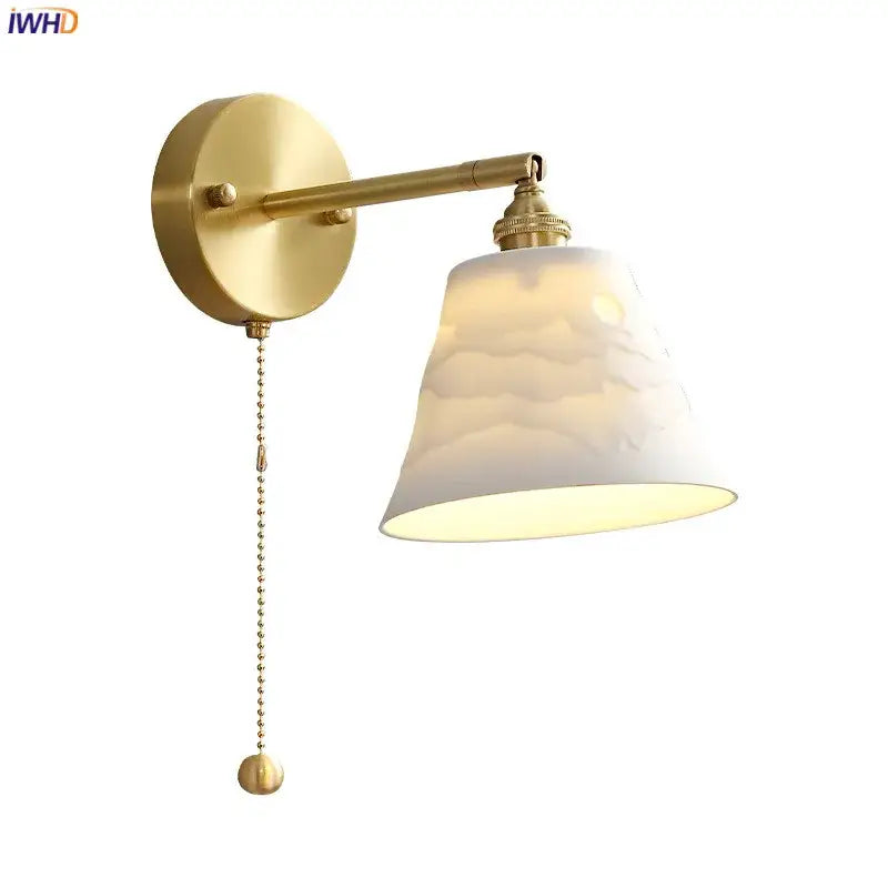 Gold-finished vintage brass led wall lamp with scalloped white textured glass shade and pull chain for bedroom use