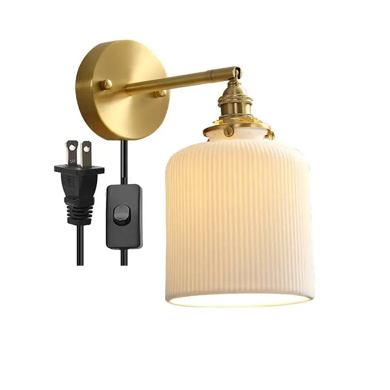 Gold-toned vintage brass led wall lamp with scalloped ribbed off-white glass shade for bedroom lighting