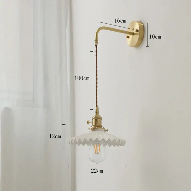 Vintage brass led wall lamp with scalloped white ceramic shade and braided cord for bedroom lighting