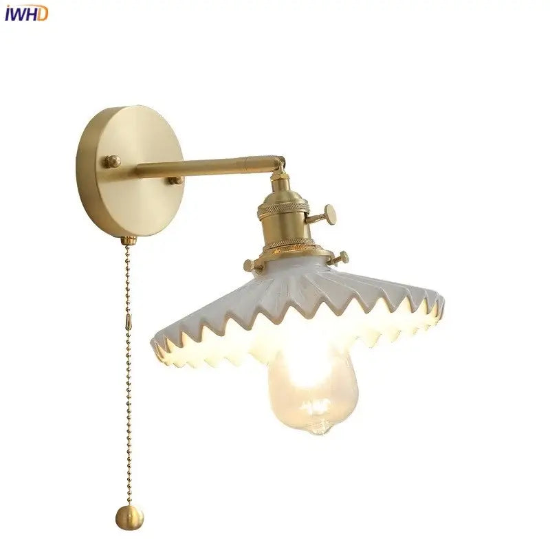 Vintage brass and scalloped glass led wall lamp with exposed bulb designed as a decorative bedroom wall lamp