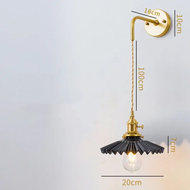 Vintage brass led wall lamp with black scalloped glass shade and exposed bulb for bedroom lighting