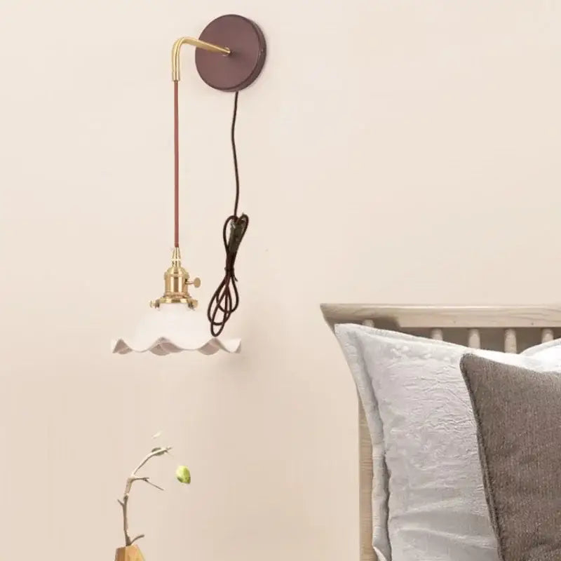 Vintage brass wall sconce with off-white scalloped glass shade for bedroom decor featuring decorbites ceramic wood led