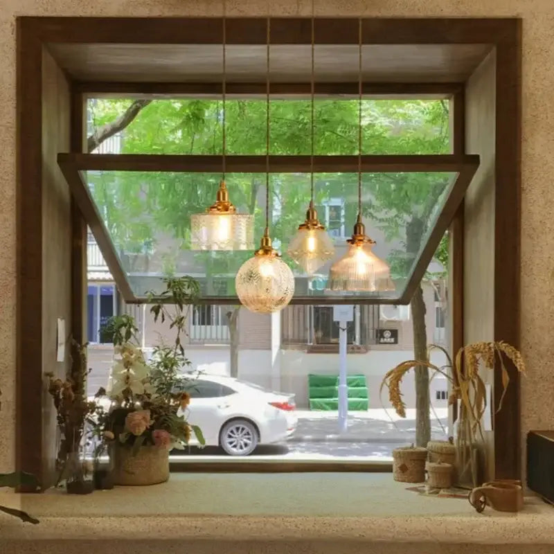 Three gold-toned vintage brass led pendant lamps with textured glass shades for dining room use