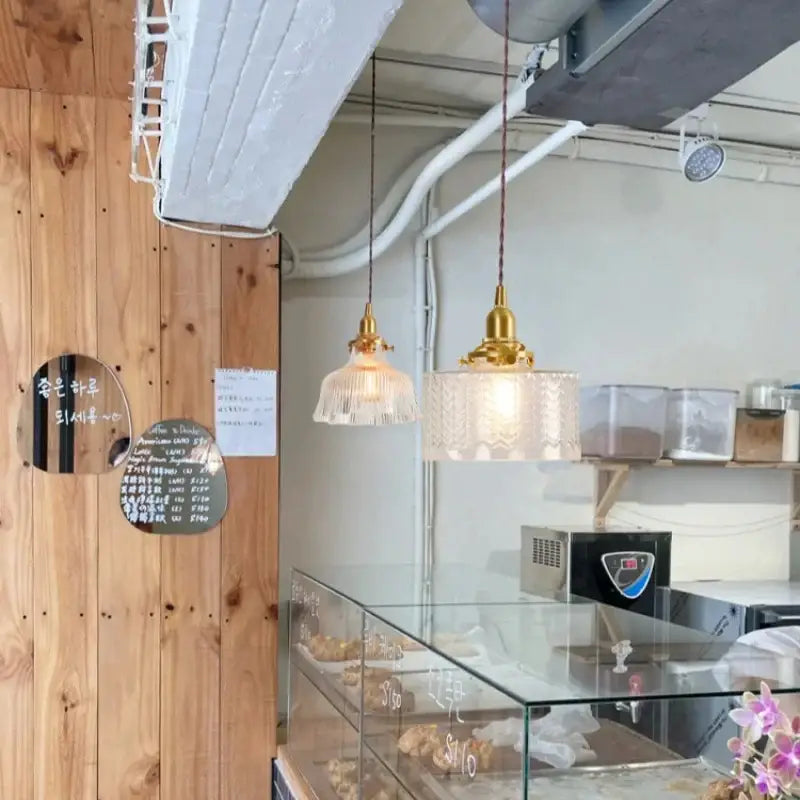Two hanging vintage brass led pendant lamps with frosted textured glass shades for dining room lighting