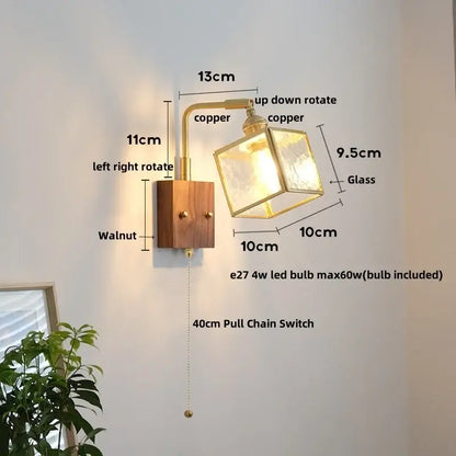 Vintage brass and walnut wall light with copper finish, frosted glass cube shade, and pull chain switch for bedroom use