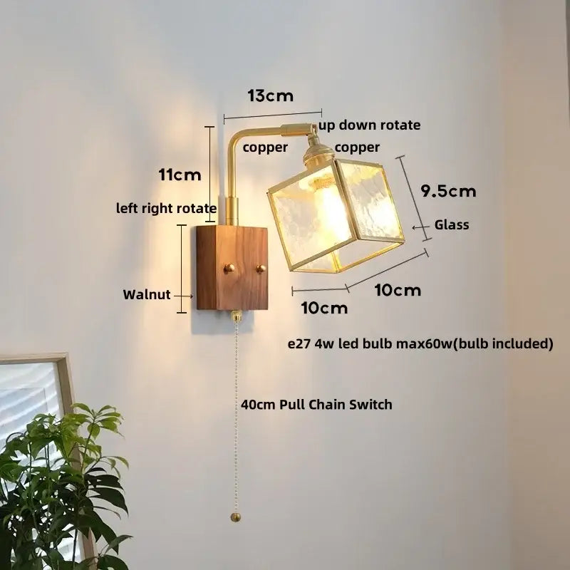 Vintage brass and walnut wall light with copper finish, frosted glass cube shade, and pull chain switch for bedroom use