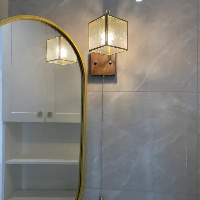 Vintage brass and walnut hexagonal glass wall light with pull chain switch and wooden backplate for bedroom use