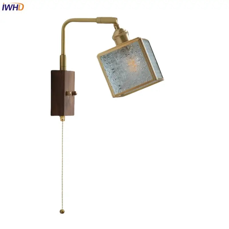 Vintage brass and walnut glass wall light with pull chain switch featuring etched floral shade and adjustable arm for bedroom use