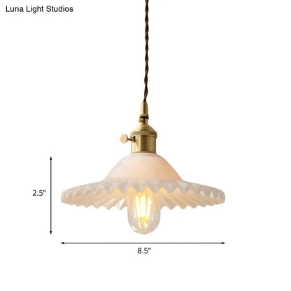 DecorBites™ Chloe scalloped pendant light with frosted white glass shade and industrial brass hardware suspended by twisted cord