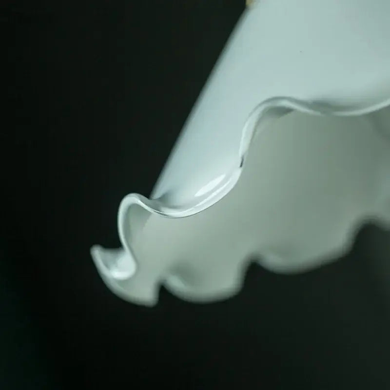 A delicate white ceramic led pendant flower with glossy finish and scalloped edge for bedroom pendant light