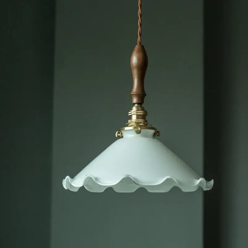 Delicate off-white glass led pendant flower light with scalloped edge and polished vintage brass fixture for bedroom use