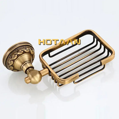 Antique brass-finished metal soap dish with ornate wall-mounted bracket and wire grid design for brass bathroom accessories set