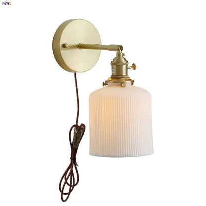 Vintage brass ceramic knob wall light with ribbed off-white glass sconce and adjustable arm for bedroom lighting