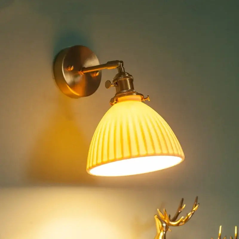 Warm-toned brass ceramic led wall lamp with ribbed yellow glass shade and pull chain switch for bedroom decorbites brass ceramic